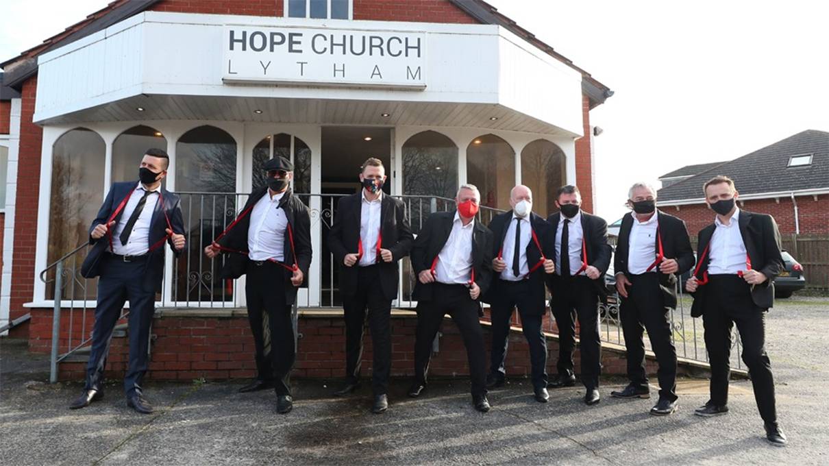 Mourners wearing red braces in honour of comedian Bobby Ball outside Hope Church in Lytham Saint Annes